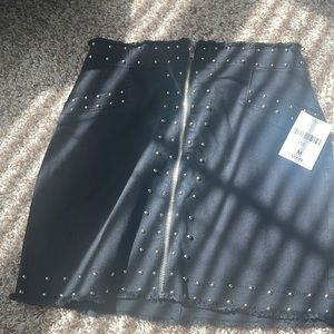 Medium denim studded black mini skirt.
